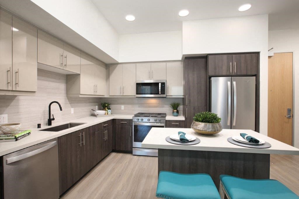 a kitchen with a table and a refrigerator