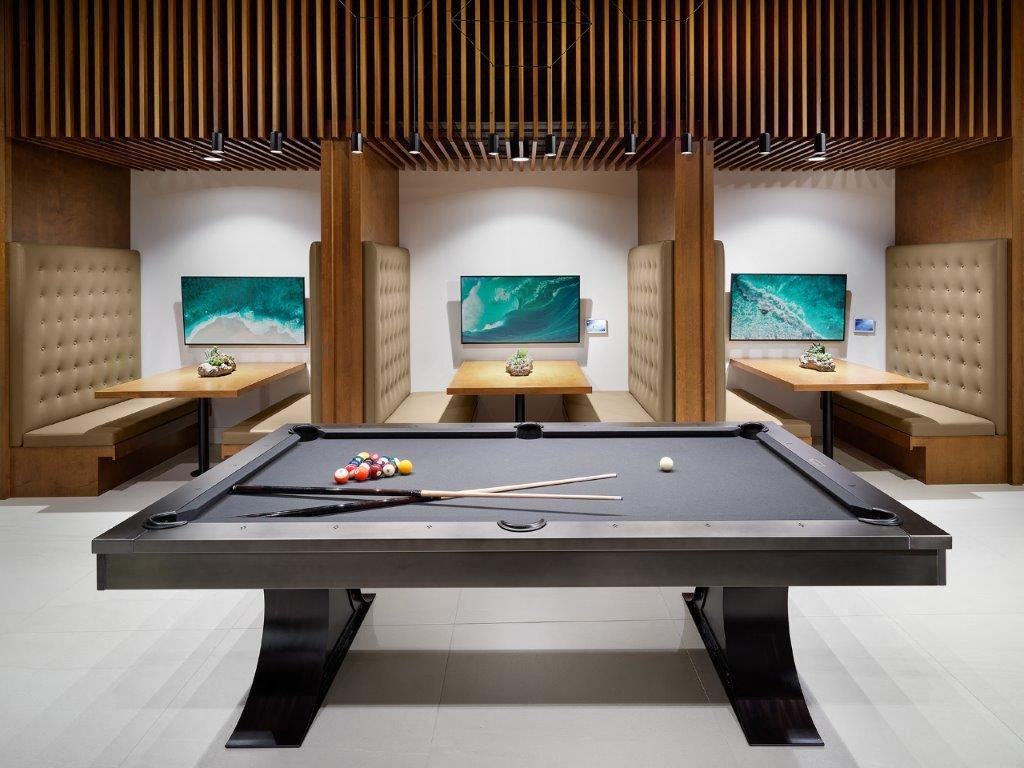 a billiards table in a living room with other furniture