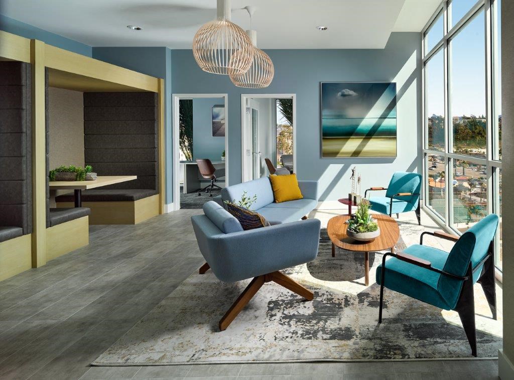 a living room with blue walls and a large window