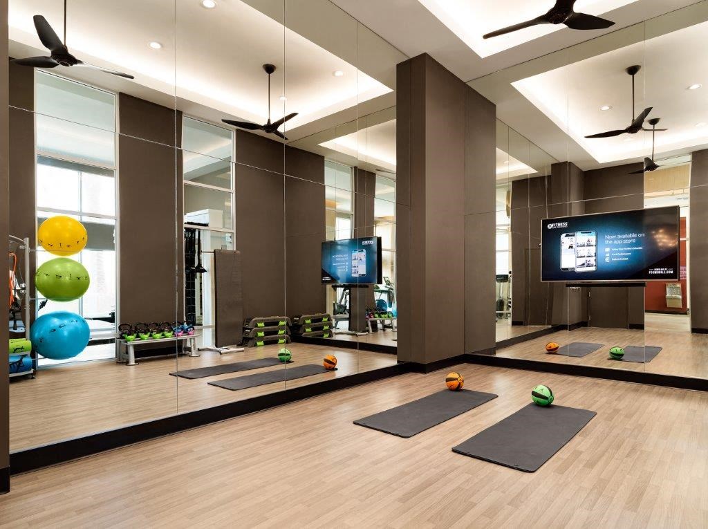 a yoga room with yoga mats and a television in the corner