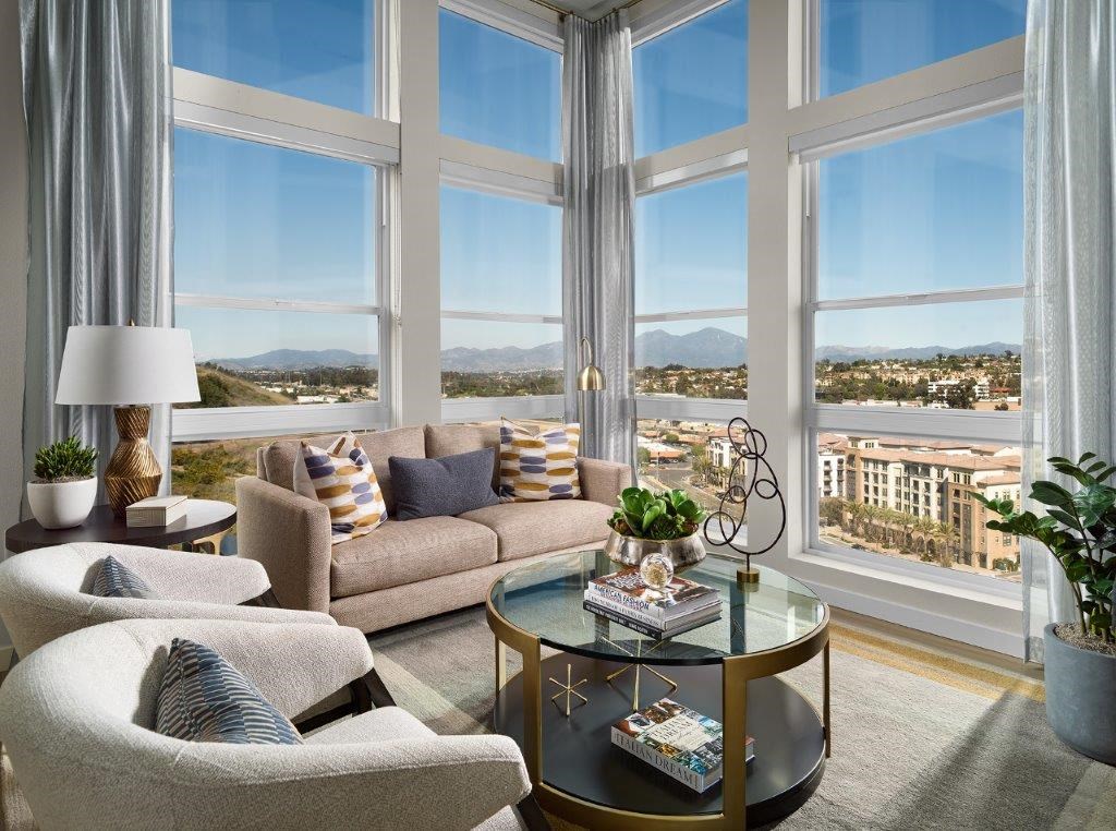 a living room with a view of a city and a large window