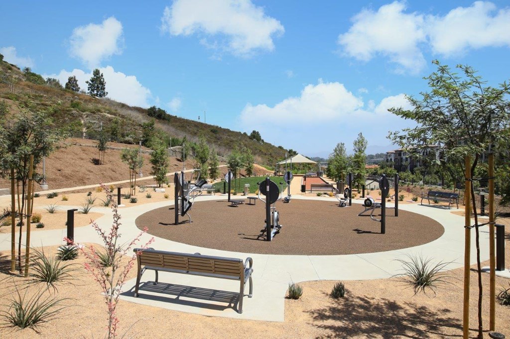 a park with benches and trees and a playground