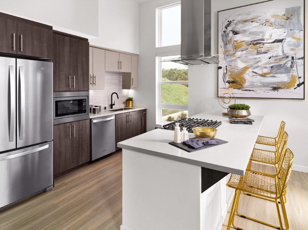 a kitchen with stainless steel appliances and a white counter top