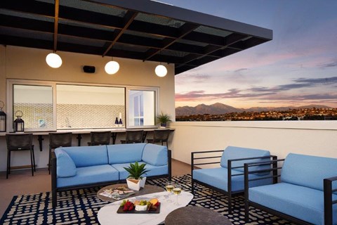 a living room with blue couches and a table