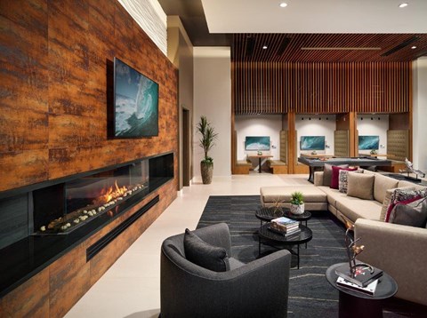 A modern living room with a fireplace and a large painting on the wall.
