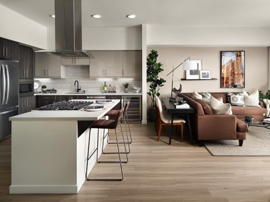 a kitchen and living room with a table and chairs