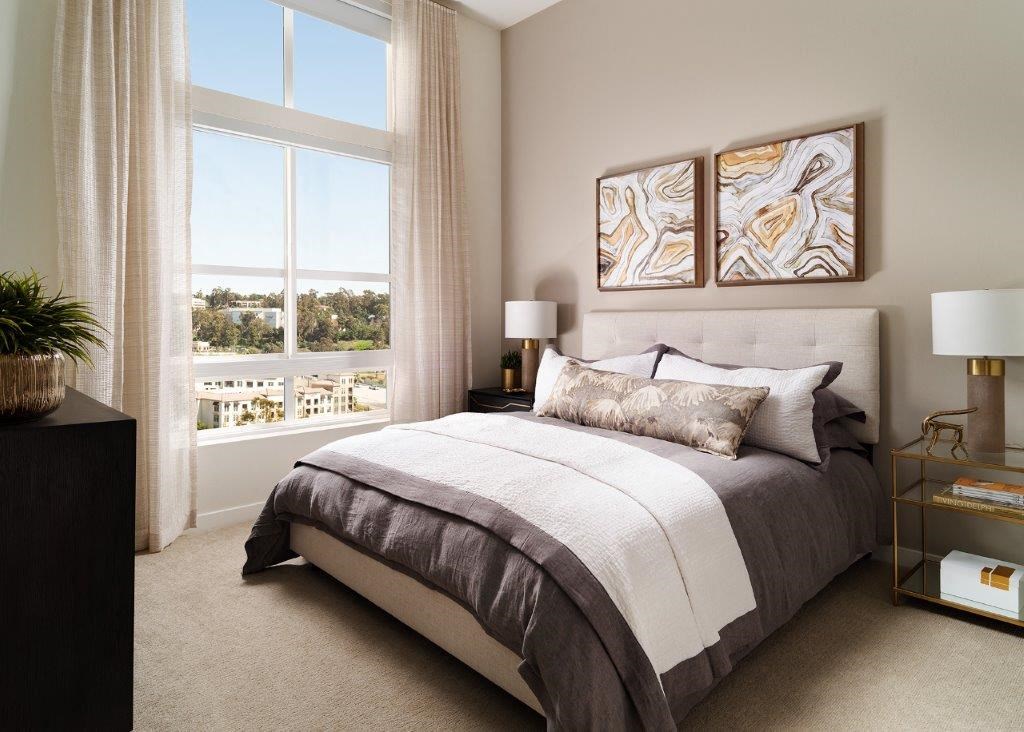 a bedroom with a large window and a bed