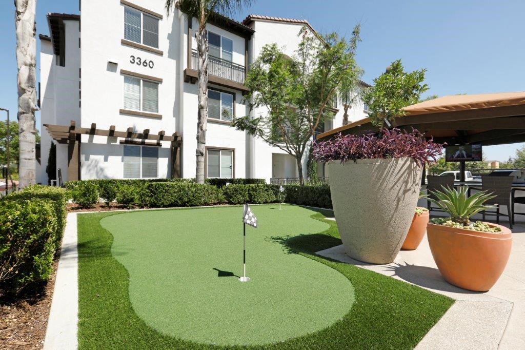 a putting green in front of an apartment building