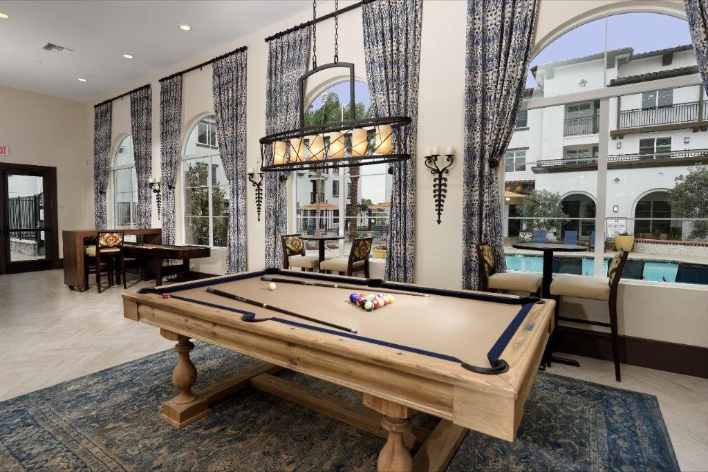 a pool table in a living room with a patio