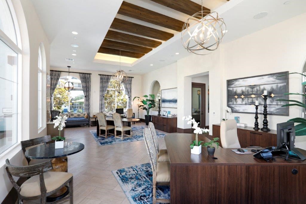 a living room and dining room with a table and chairs