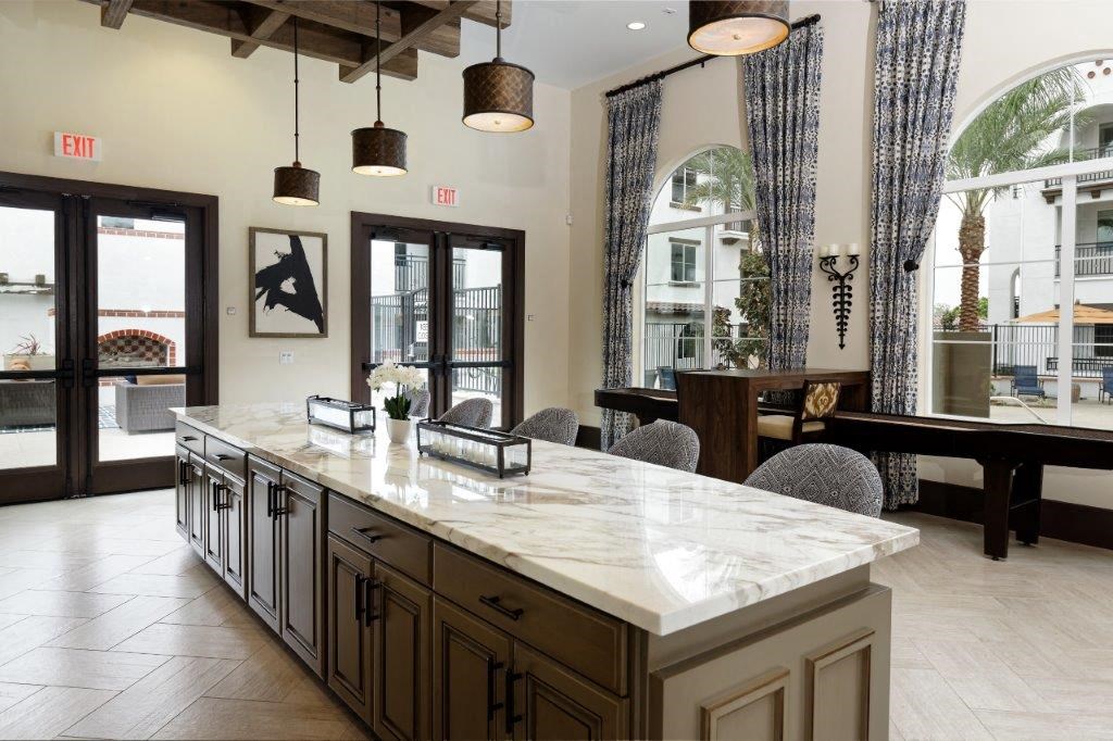 a large kitchen with a marble counter top