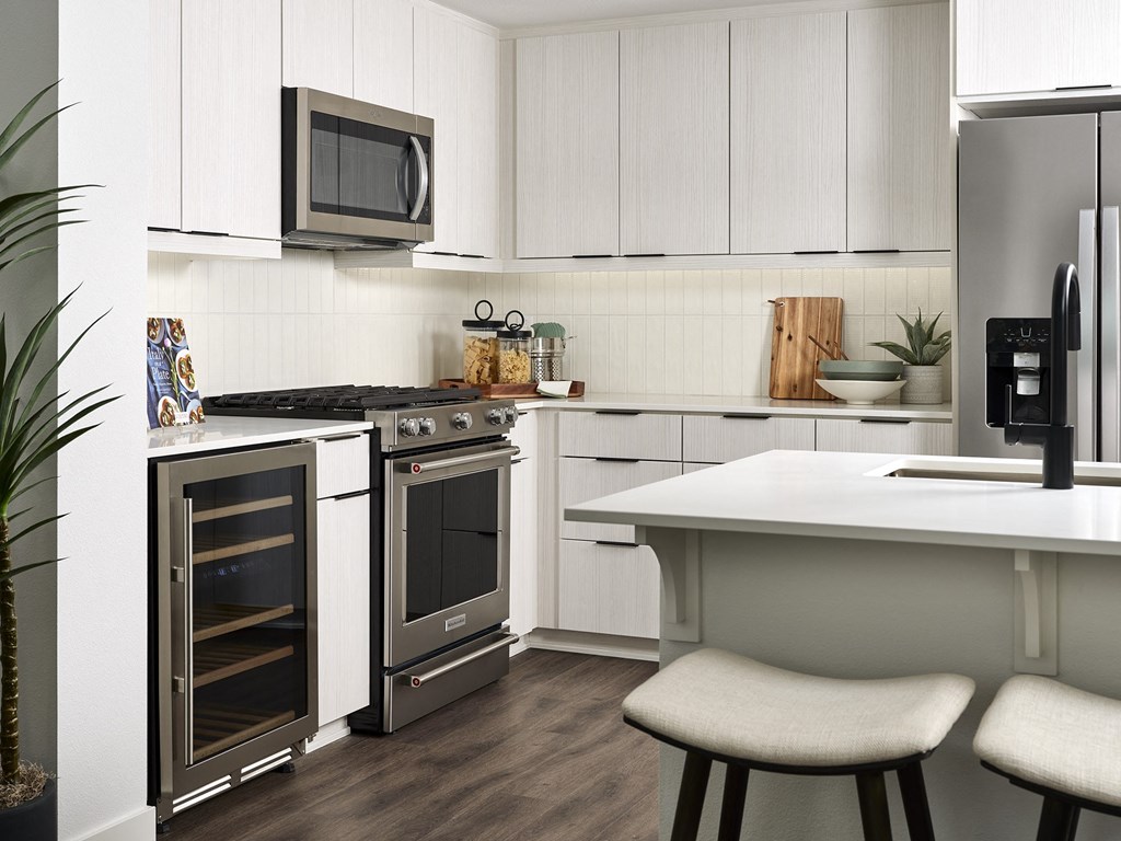 a kitchen with stainless steel appliances and white cabinets