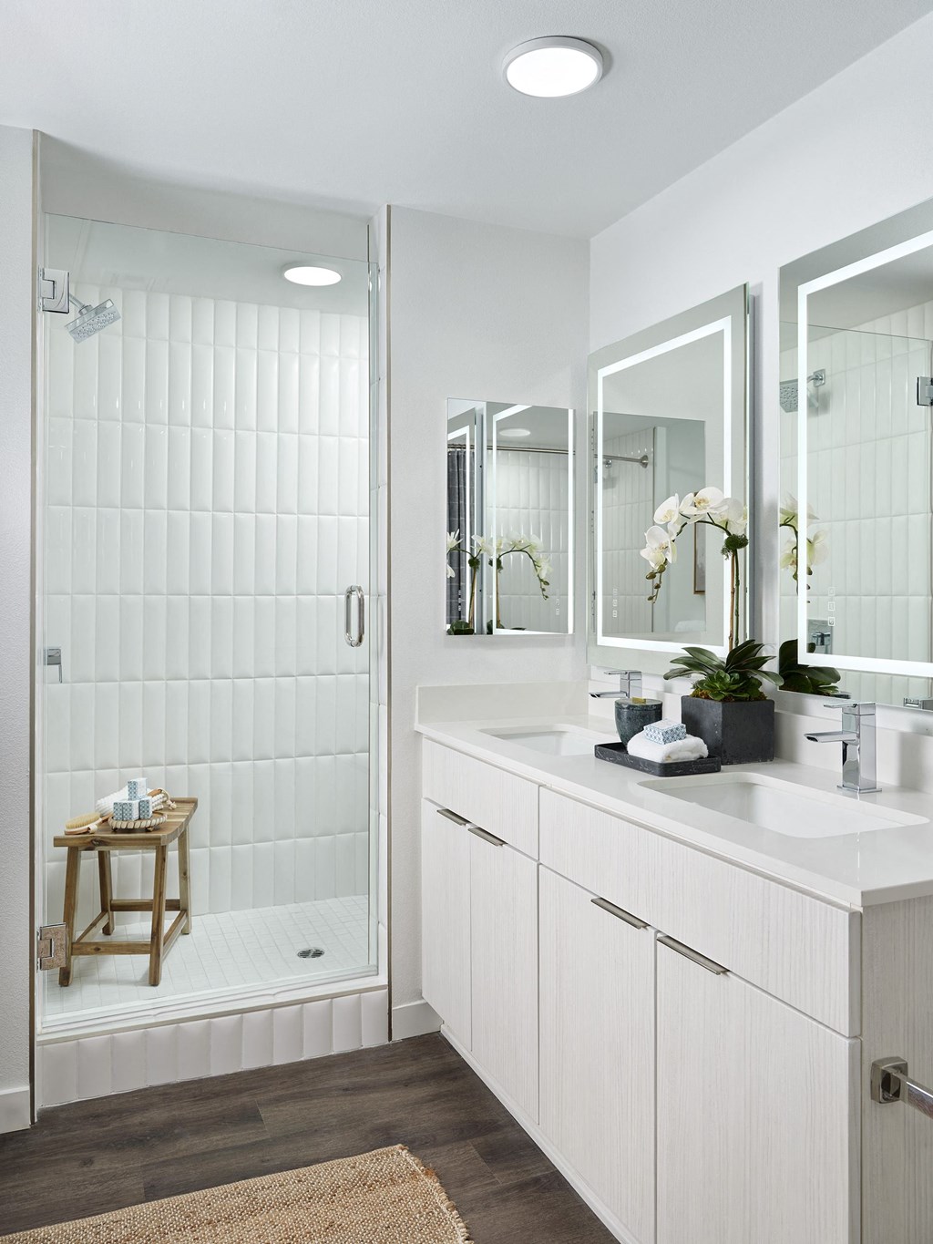 a white bathroom with a shower and a sink