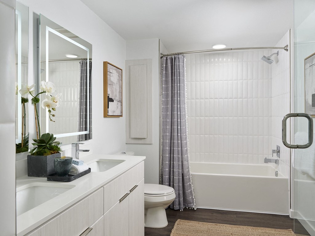 a bathroom with a shower and a toilet and a sink