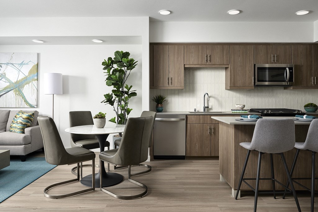 a living room and kitchen with a table and chairs