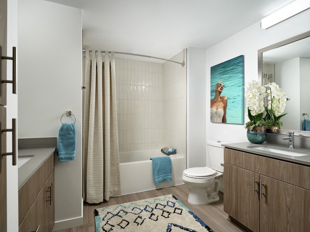 a bathroom with a shower and a toilet and a sink