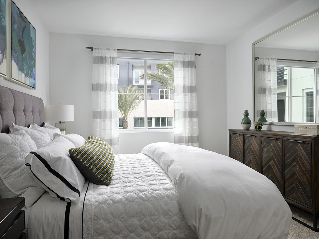 a bedroom with a large bed and a window