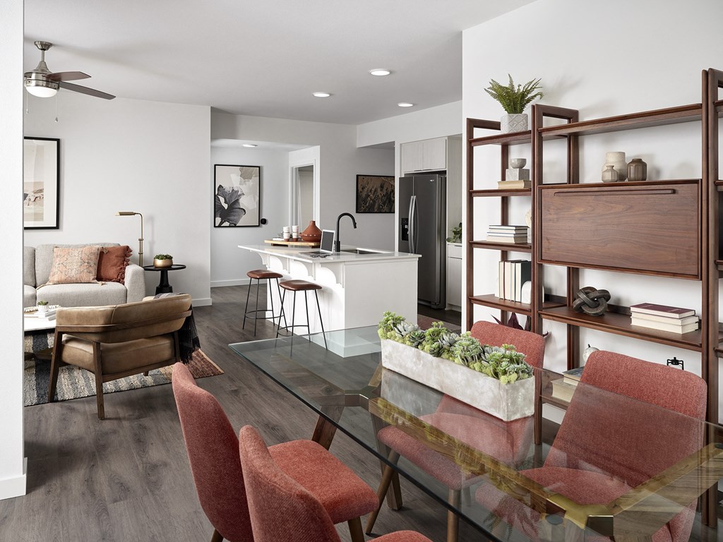 a living room and dining room with a glass table