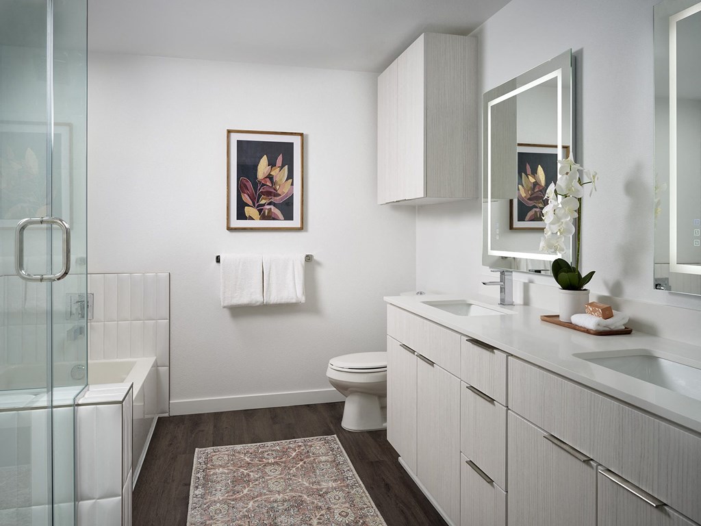 a bathroom with a toilet and a sink and a shower