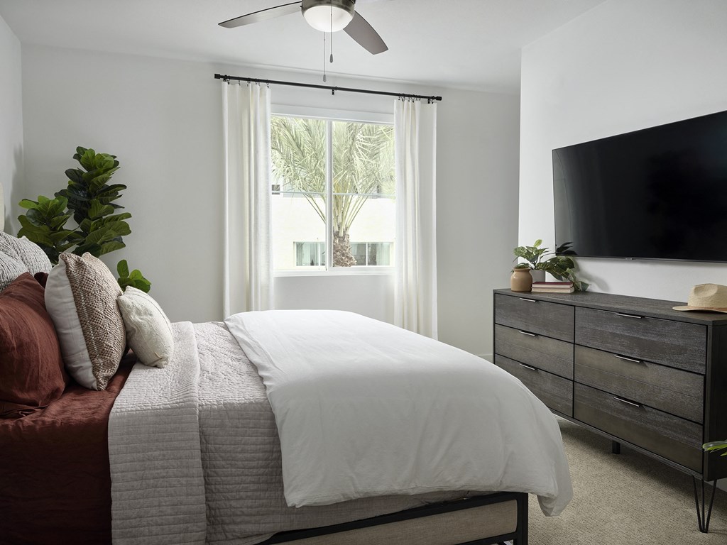 a bedroom with a bed and a tv