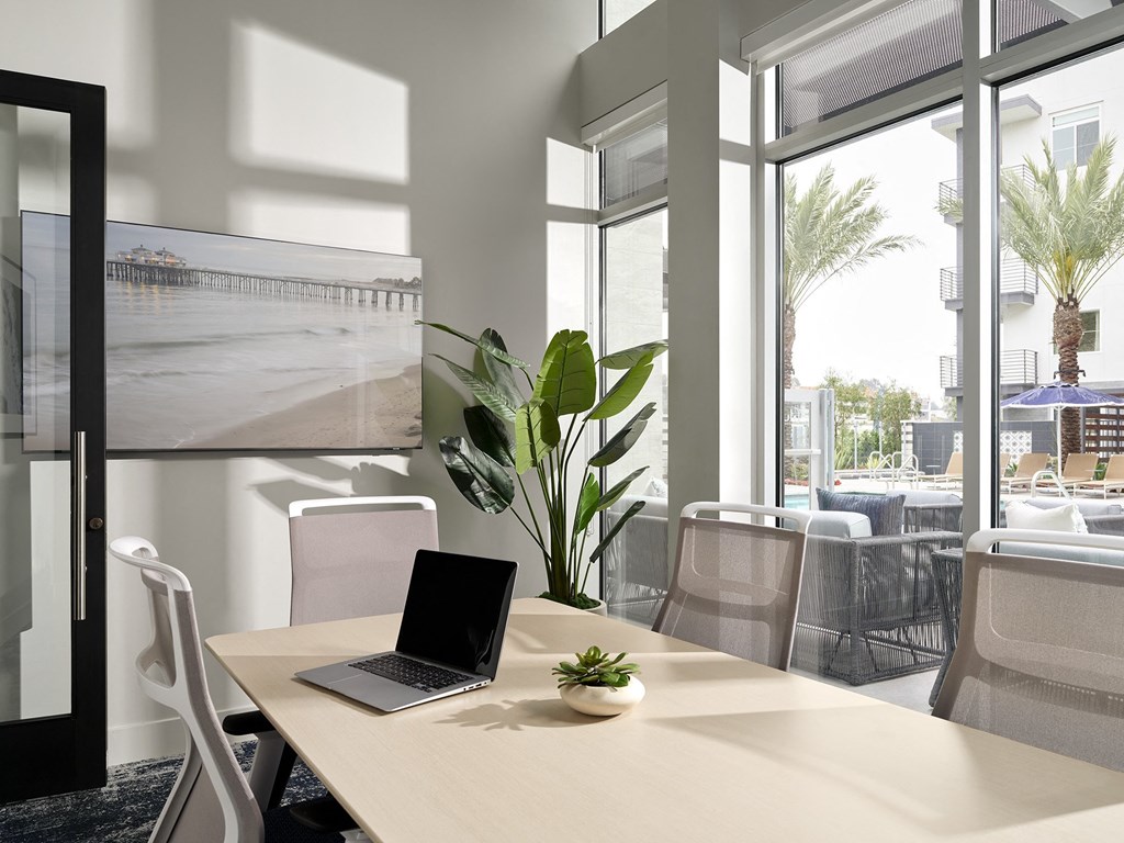 a conference room with a laptop on a table