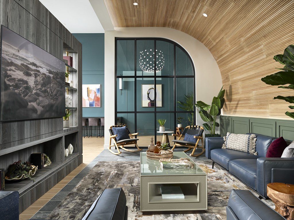 a living room with blue furniture and a large window