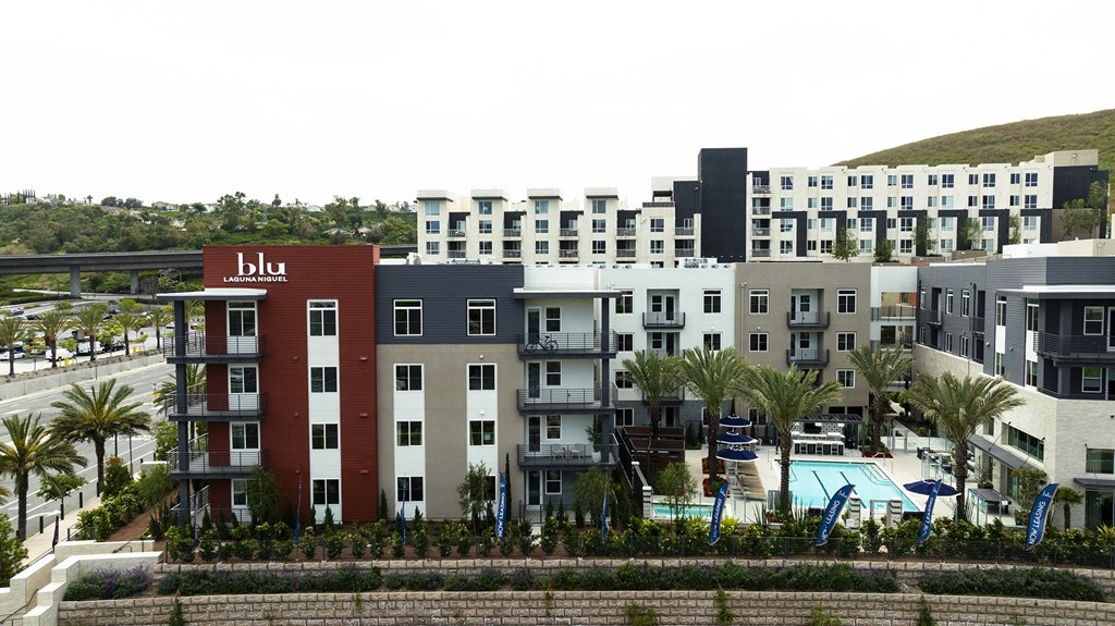 an aerial view of an apartment complex with a swimming pool