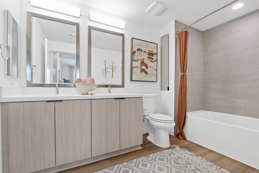 a bathroom with a sink and a toilet and a shower