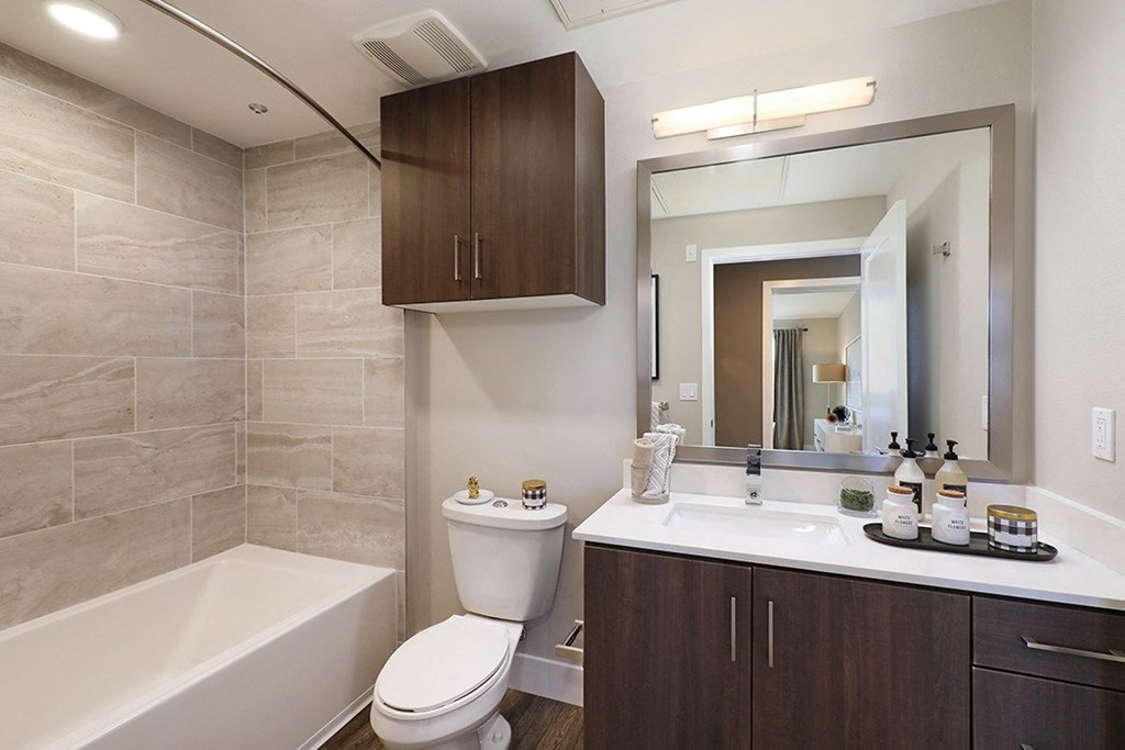 a bathroom with a sink toilet and a mirror