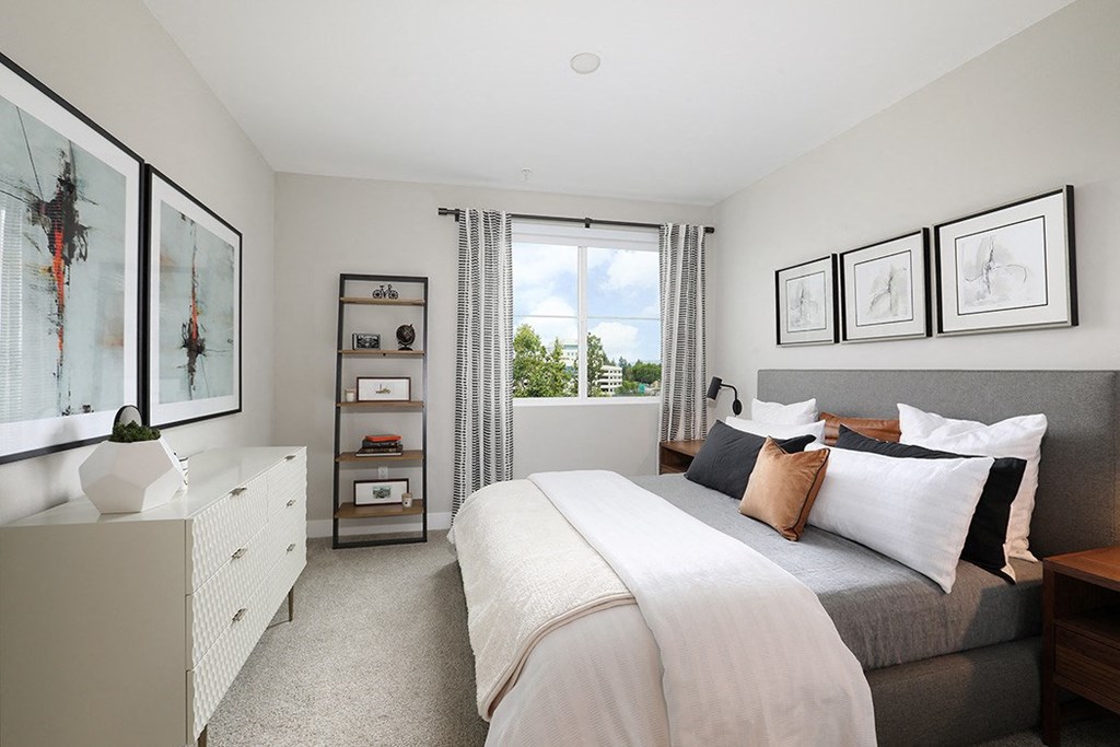 a bedroom with a bed and a window