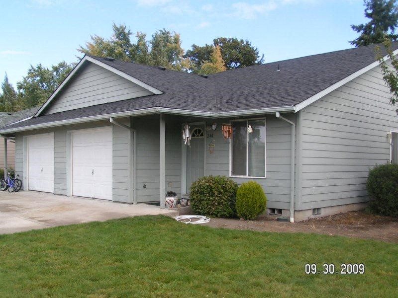 Exterior view of duplex unit, showing entry and single car garage