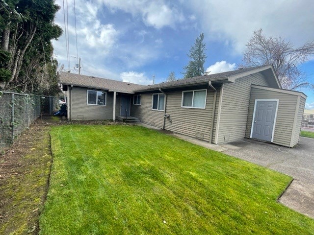 Apartment Exterior, showing yard area and exterior storage shed.