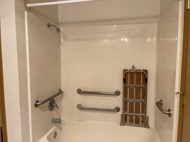 Bathtub with fold down seat and grab bars