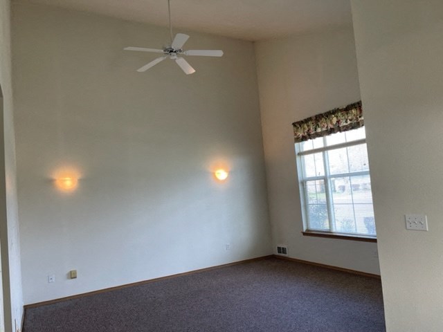 Spacious living room with ceiling fan