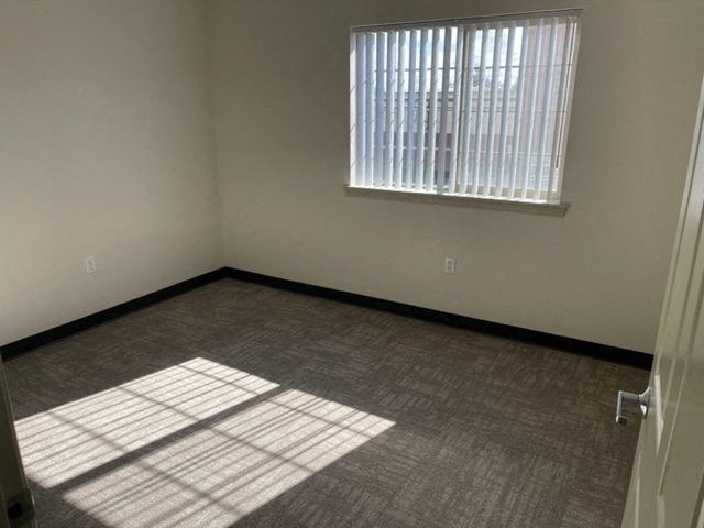 Bedroom with large window and vertical blinds