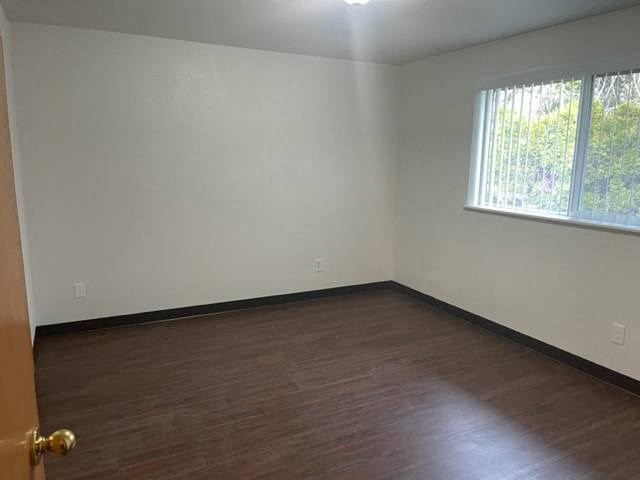 Bedroom 2 with large window and vertical blinds