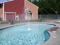 A small pool with a fountain in the middle.