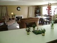 A living room with a couch, chair, and table.
