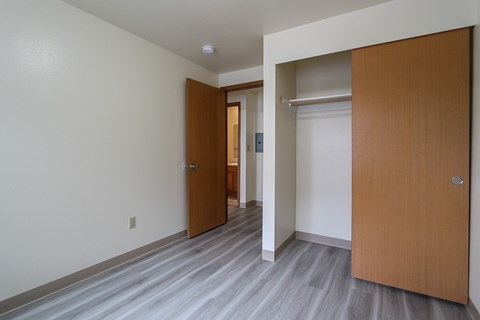 A hallway with two doors and a grey floor.