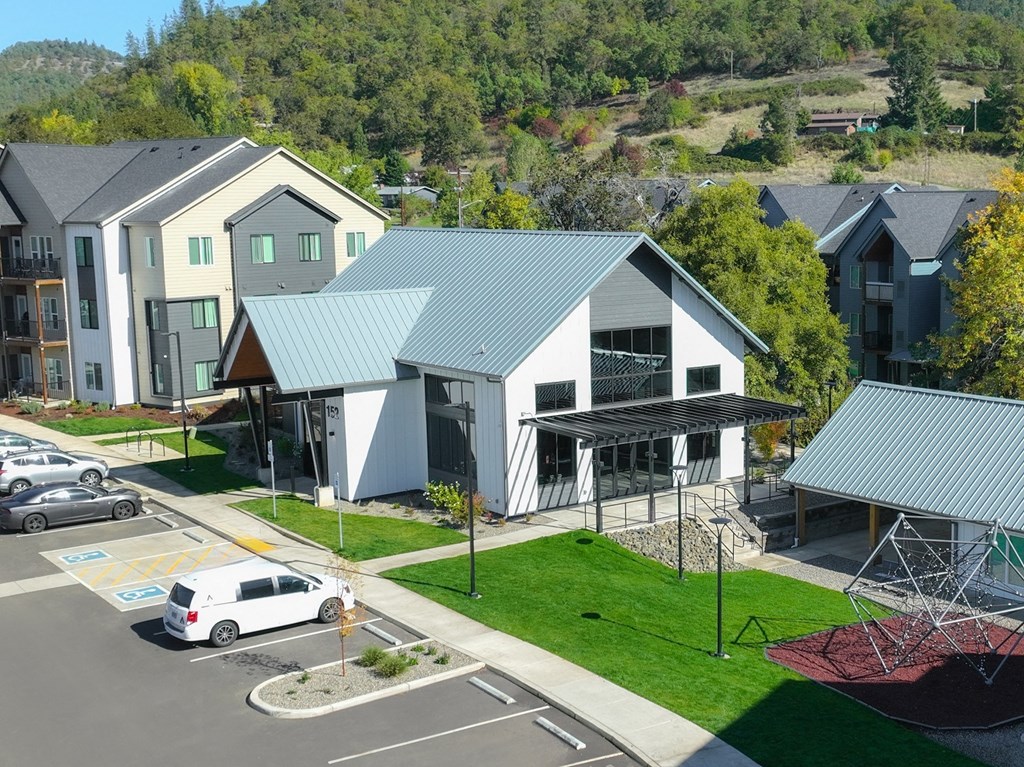 a group of houses with blue roofs next to a street