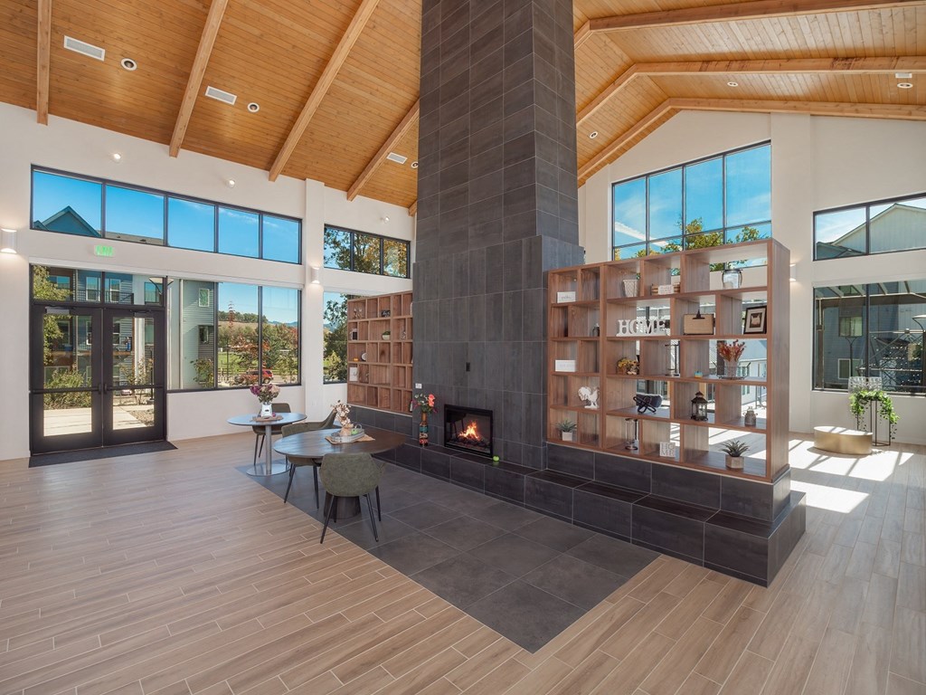a large living room with a fireplace and a book shelf