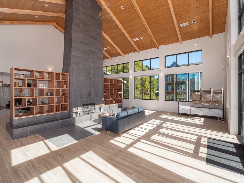 a large living room with wood floors and a large fireplace