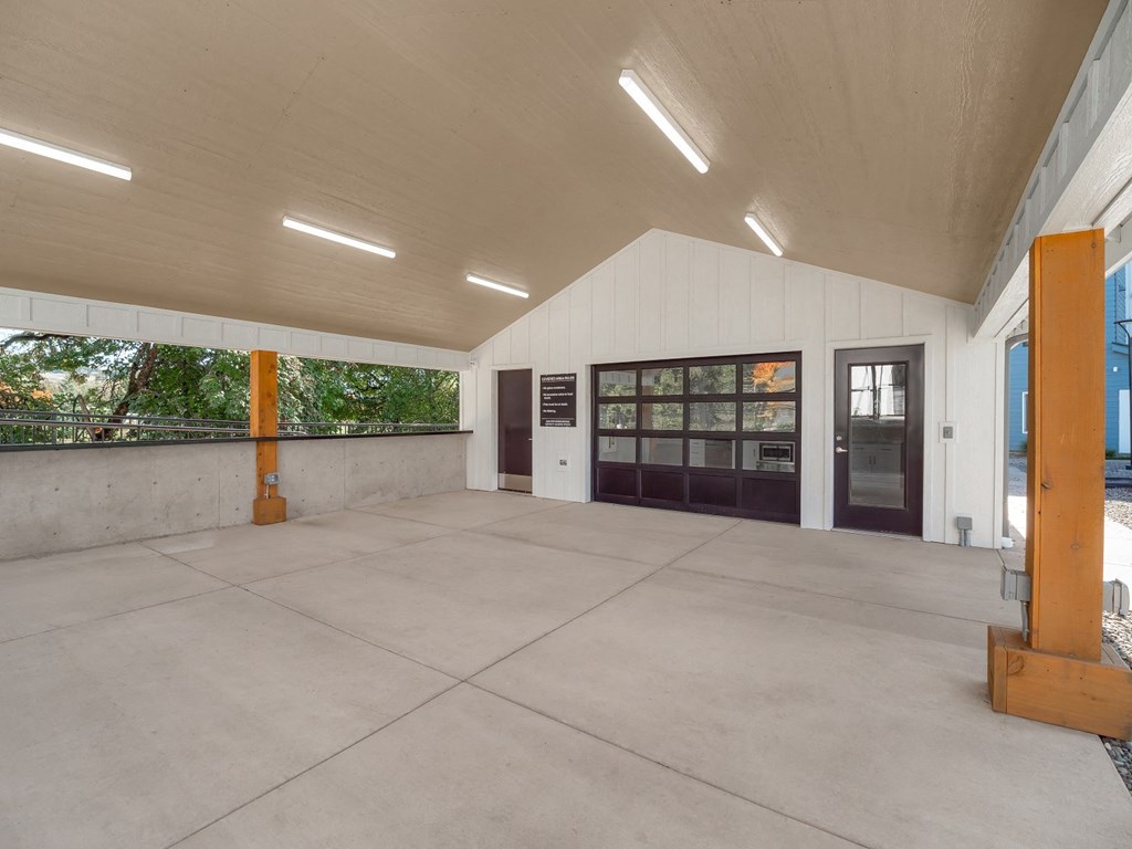 the inside of a building with a concrete floor and a door