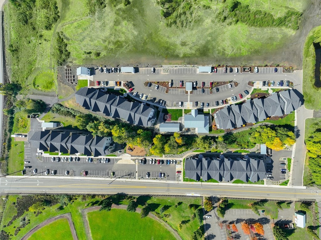 a birds eye view of a parking lot with cars and buildings