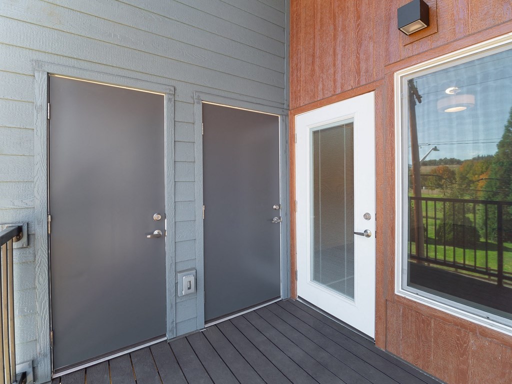 a porch with two doors and a glass window
