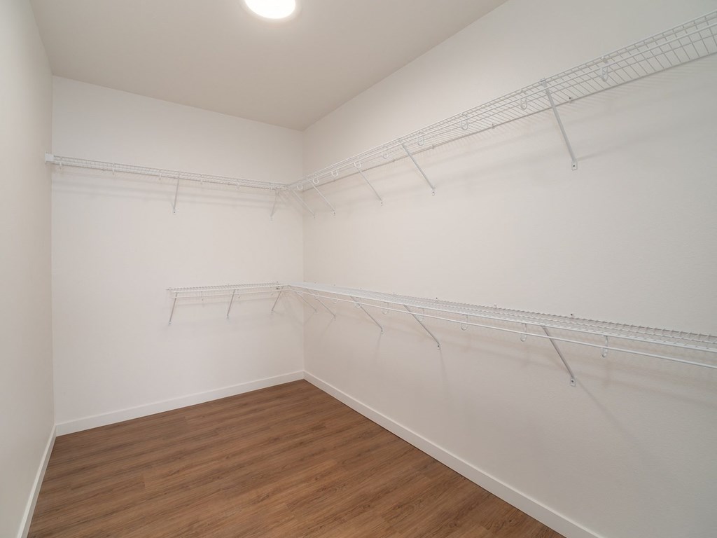 an empty room with white walls and a wood floor