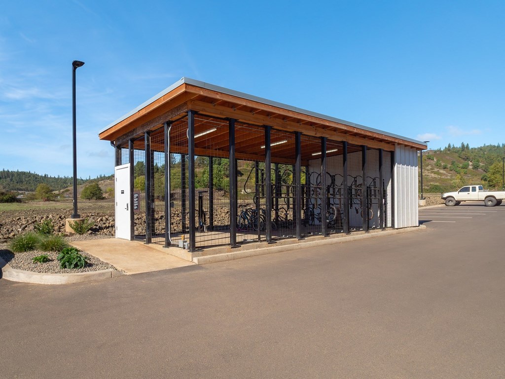 a bike rack in a parking lot next to a building