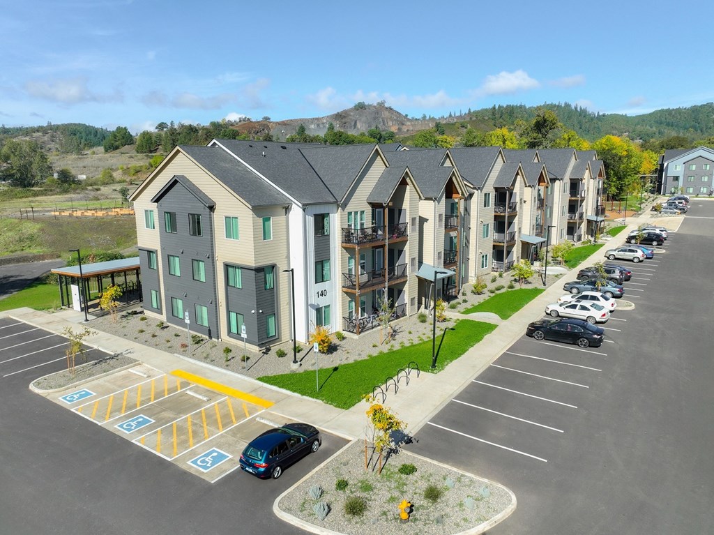 an aerial view of an apartment complex with a parking lot