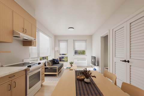 A modern kitchen with wooden cabinets and a dining table set for two.