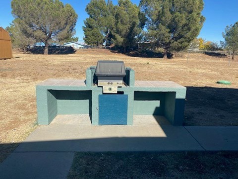 A blue and green outdoor table with a television on it.